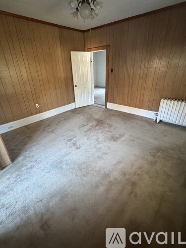 A room with wooden walls and a carpeted floor.