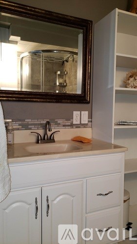 A bathroom with a sink and a mirror.