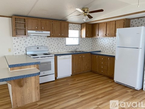 A kitchen with wooden cabinets and a white fridge.