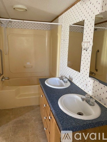 A bathroom with a tan tub and sink.