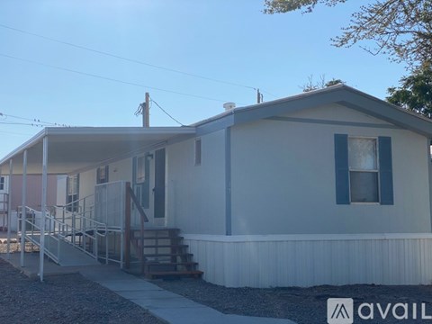 A house with a porch and a staircase leading to the entrance.