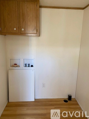 A kitchen with wooden cabinets and a white refrigerator.