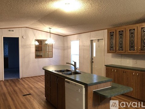 A kitchen with wooden cabinets and a green countertop.