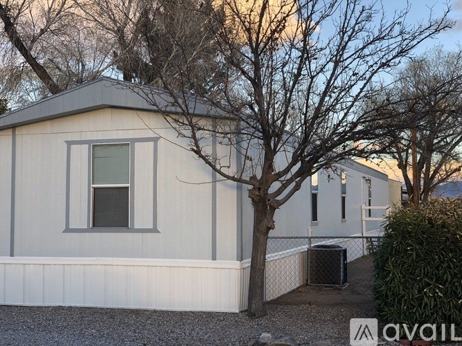 A house with a tree in front of it.