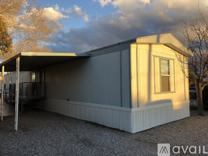 A modern house with a grey exterior and a balcony.