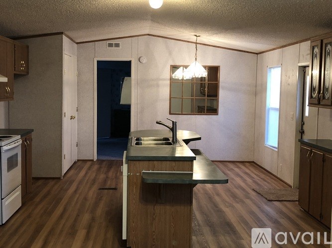 A kitchen with a sink and a stove top oven.