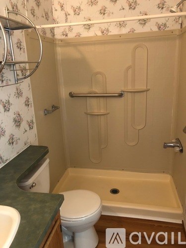 A bathroom with a toilet, sink, and bathtub.