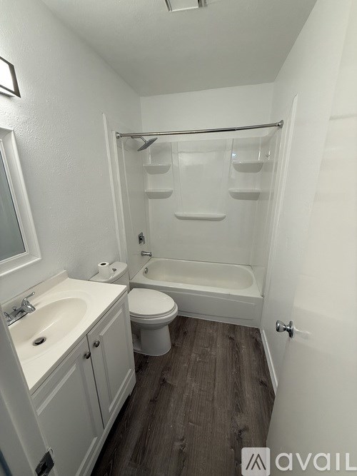 A bathroom with a toilet, sink, and bathtub.
