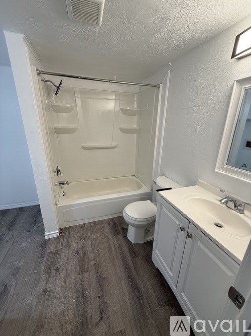 A bathroom with a toilet, sink, and bathtub.