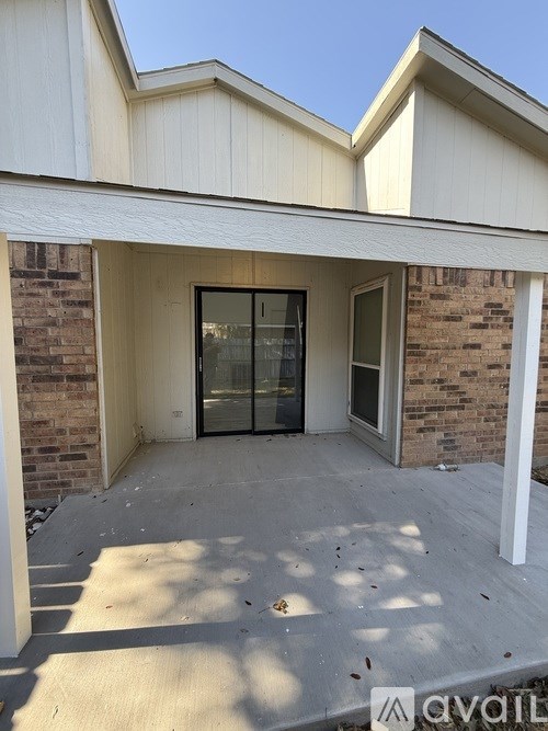 A house with a glass door and a concrete floor.