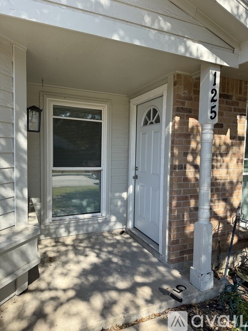 A white door is on the right side of a house.