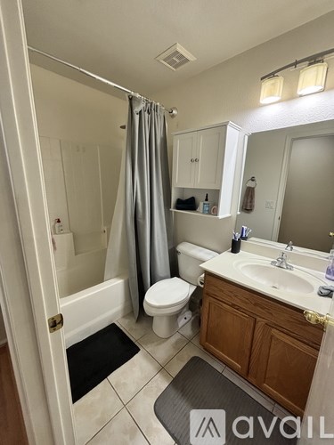 A bathroom with a toilet, sink, and shower.