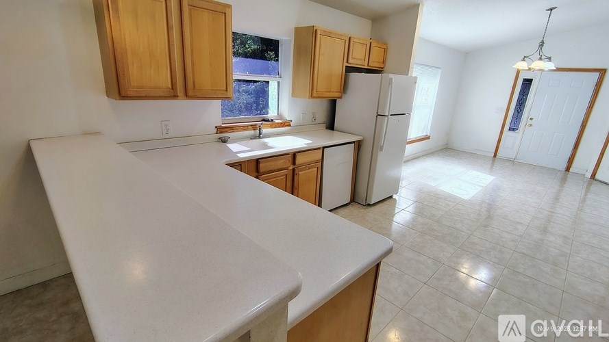 A kitchen with wooden cabinets and a white countertop.