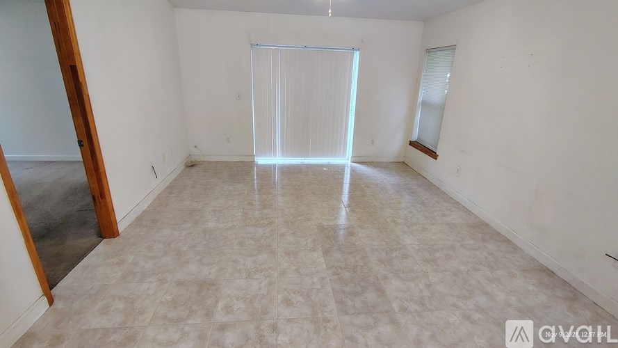 A room with a tiled floor and a large window.