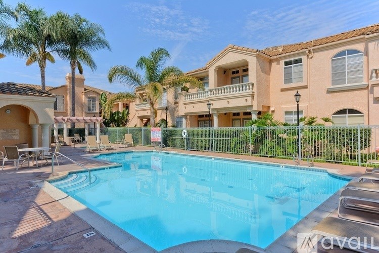 A swimming pool in front of a row of houses.