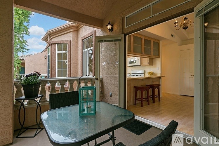 A table with a green object on it is in the middle of a patio.
