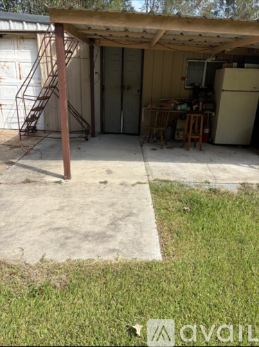 A garage with a refrigerator and a chair inside.
