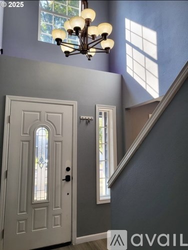 A white door with a glass window is set in a blue wall.