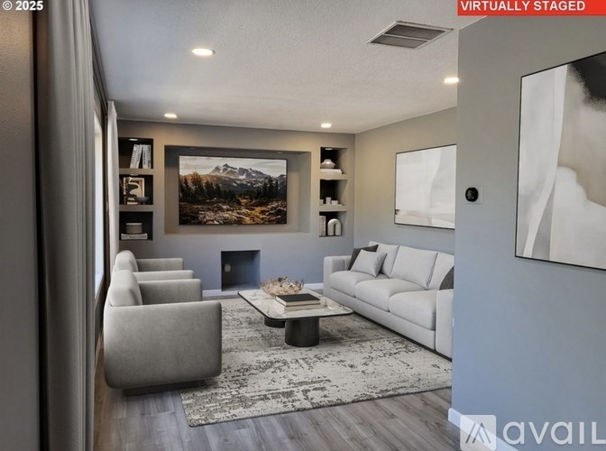 A modern living room with a grey sofa, a coffee table, and a large painting on the wall.