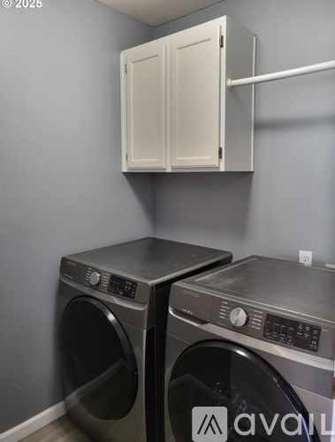 Two front load washing machines in a laundry room.