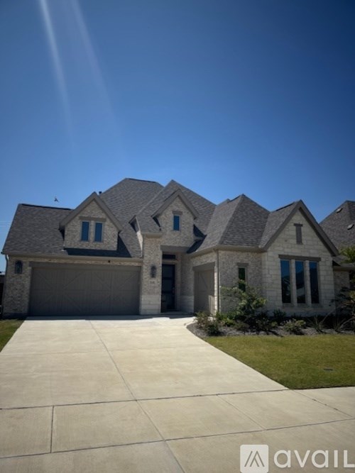 A house with a grey roof and a garage door.