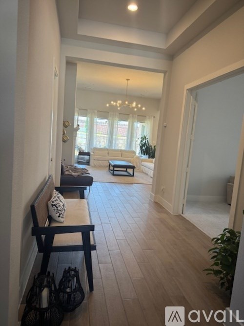 A living room with a couch, a chair, and a table.