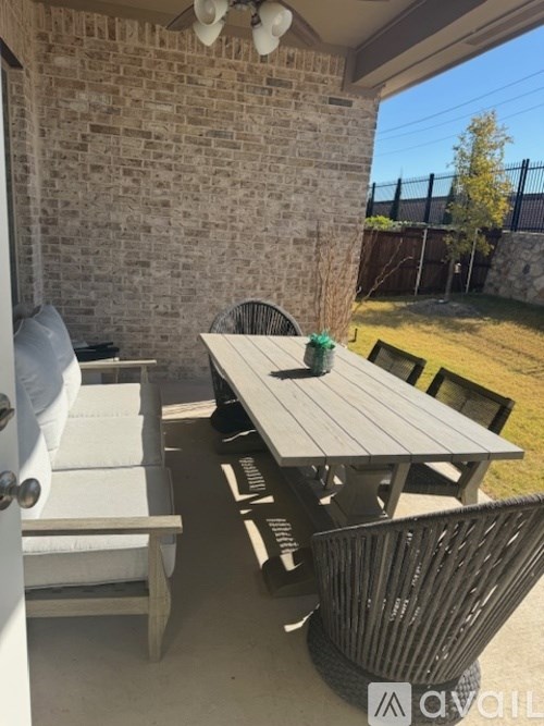 A patio with a table and chairs.