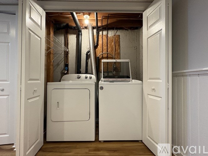 A small laundry room with a washer and dryer.