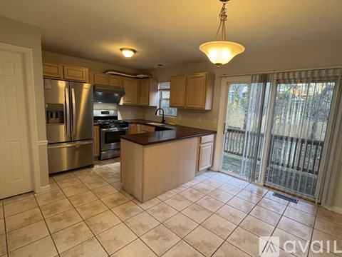 A kitchen with a refrigerator, stove, and oven.