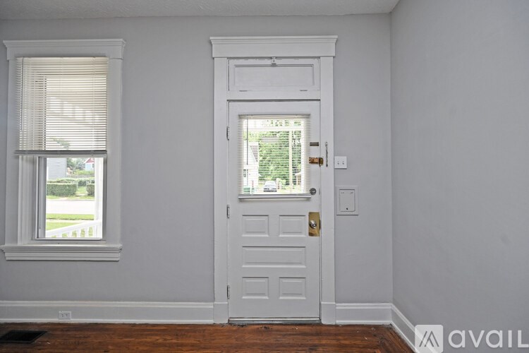A white door with a window on the left side.