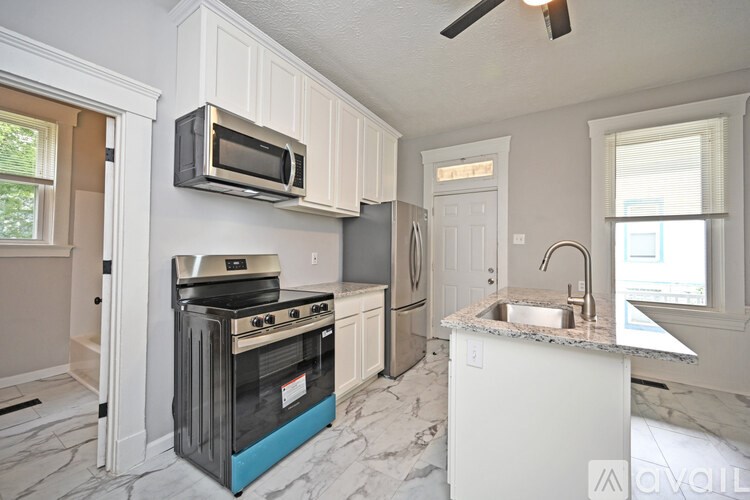 A kitchen with a stove top oven and a microwave above it.