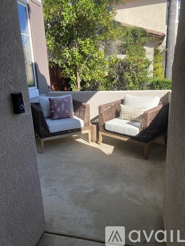 A patio with two chairs and a table.