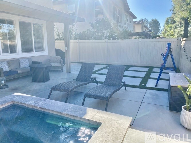 A pool with a table and chairs around it.