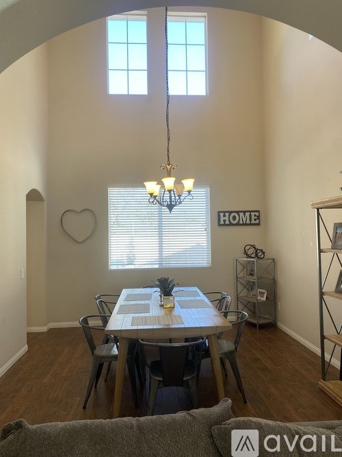 A dining room with a table and chairs.