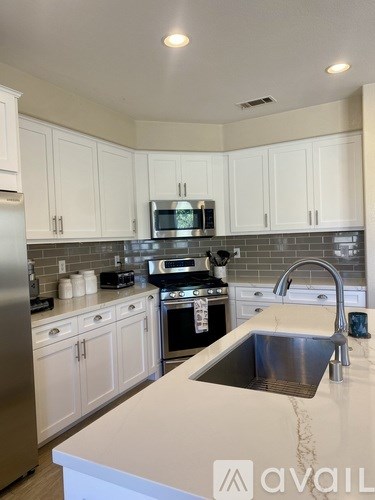 A kitchen with a sink and a microwave.