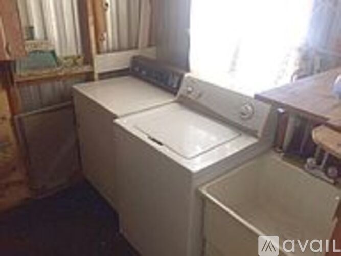 A washing machine is sitting in a room.