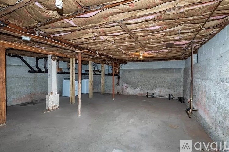A room with a brown ceiling and concrete floor.
