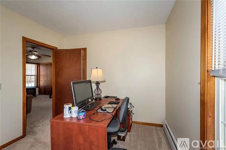 A room with a desk and a computer on it.