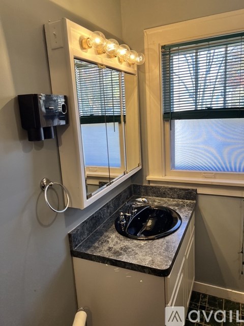 A white sink with a drain in the middle of it.