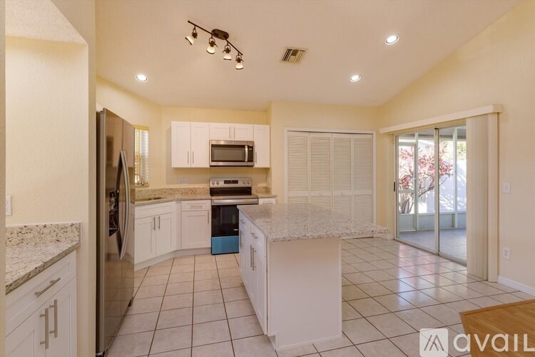 A kitchen with granite countertops and stainless steel appliances.