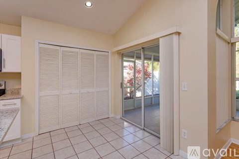 A kitchen with white cabinets and a tiled floor.