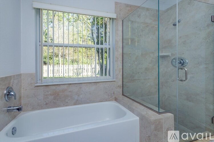 A bathroom with a tub and a window.