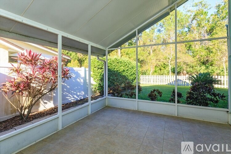A patio area with a white roof and tiled floor.