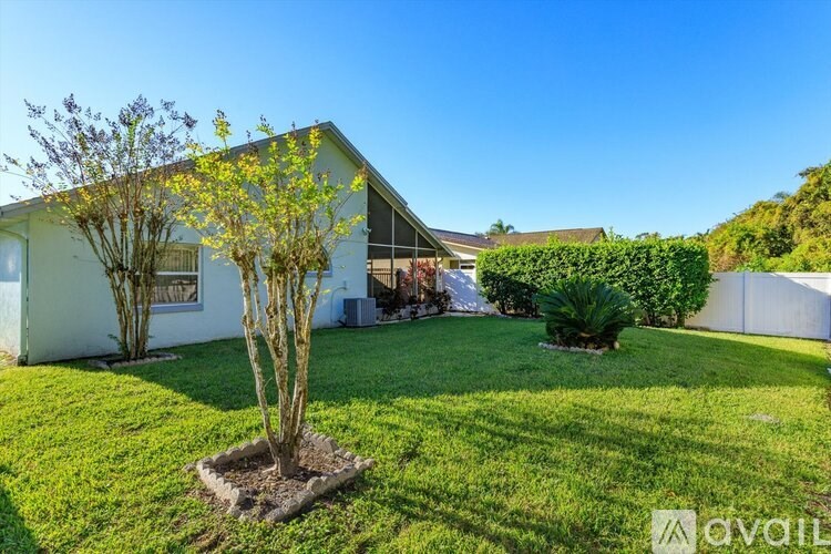 A house with a tree in the front yard.