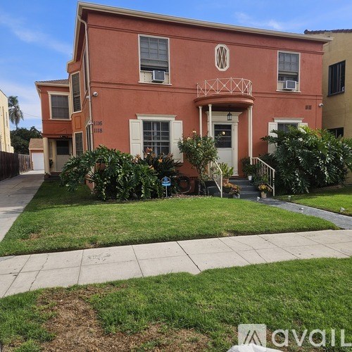 A red house with a white door and windows.