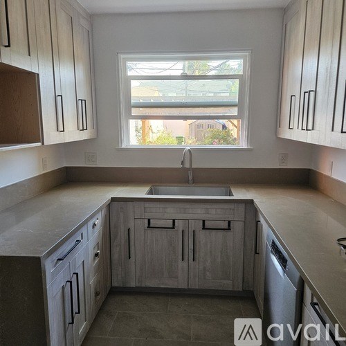 A kitchen with wooden cabinets and a window.