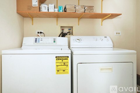 Two white EnergyWise washing machines in a laundry room.