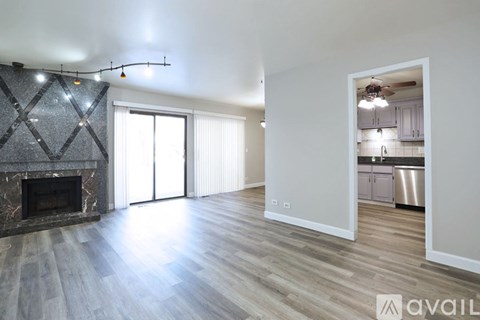 A spacious living room with a fireplace and sliding glass doors.