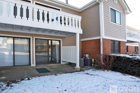 A house with a balcony covered in snow.