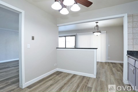 A room with a window and a ceiling fan.